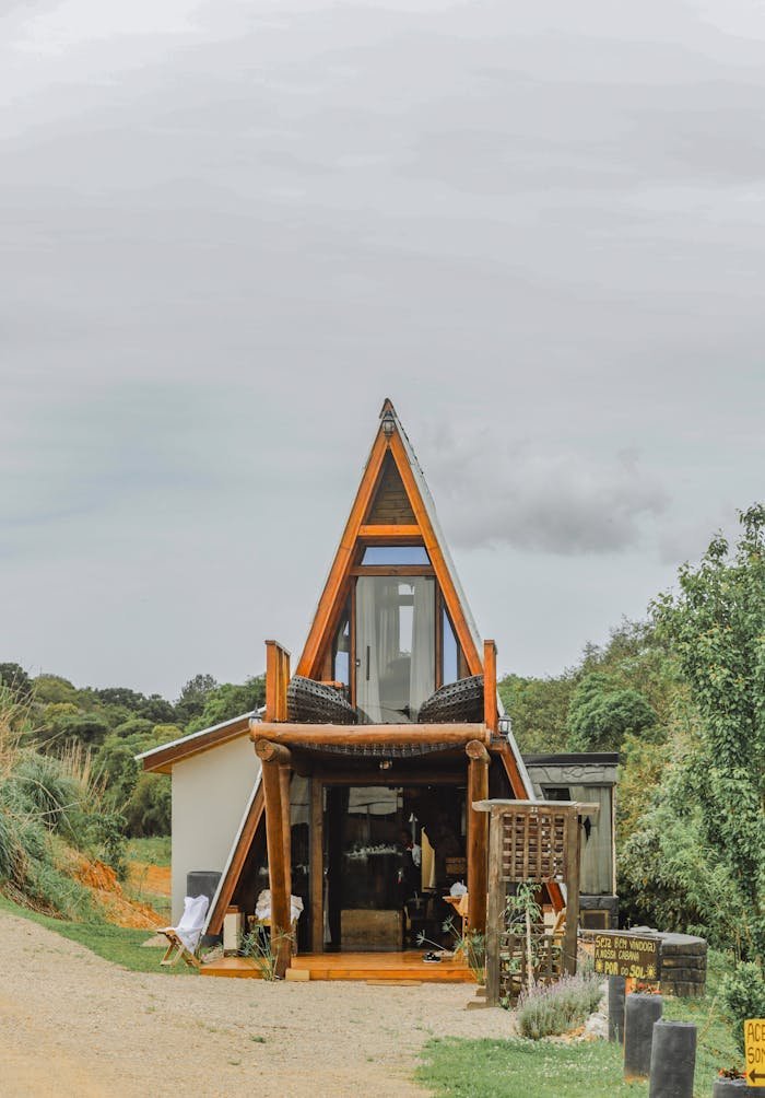 A-frame cabin nestled in nature, highlighting unique architecture and serene landscape.